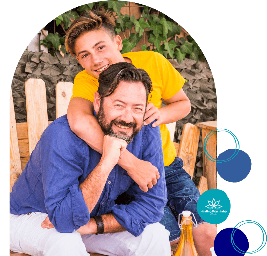 Father and teen son smiling, promoting teen therapy counseling in Altamonte Springs, Florida.